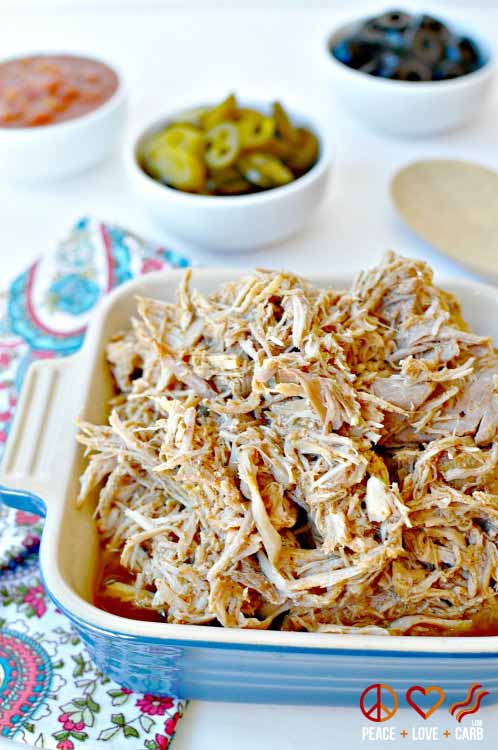 Shredded Pork On a Table With Jalapenos and Black Olives.