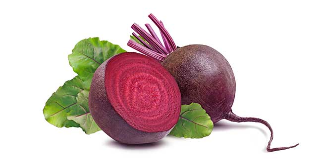 Whole Beet Root and Half Beet Root Next To Each Other.