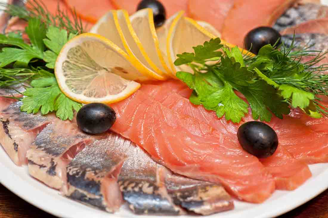 Fresh Raw Salmon With Lemon Slices and Leaf Decoration.