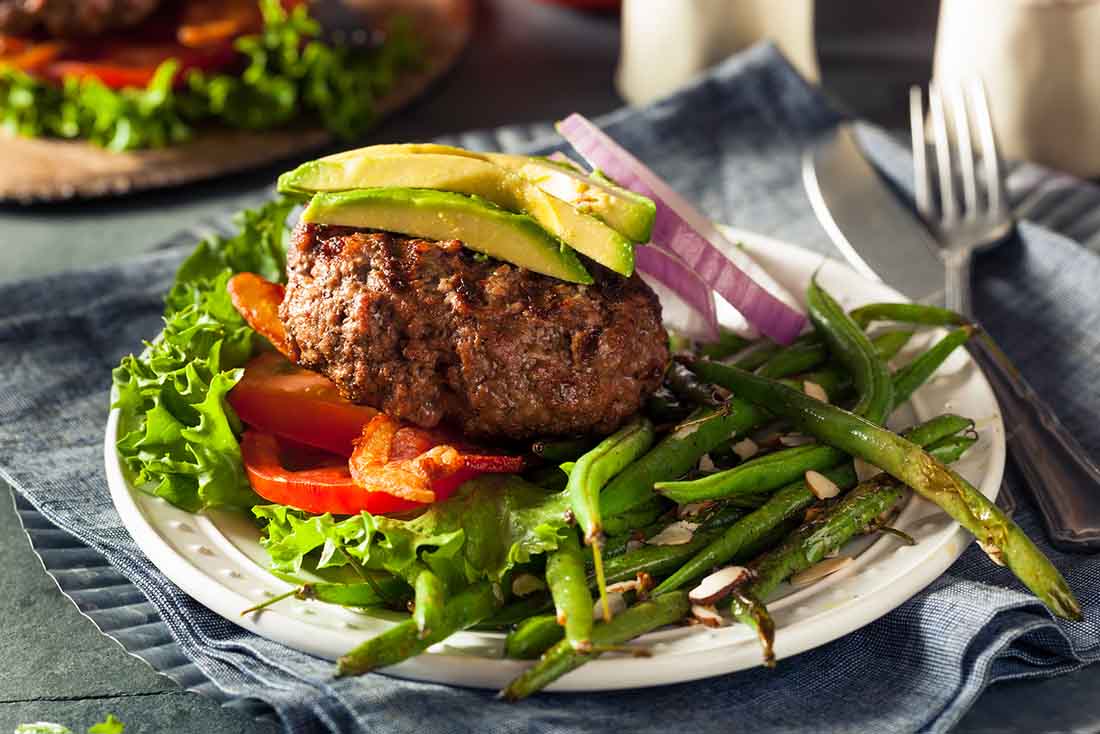 A Bunless Avocado Burger With Fresh Salad.