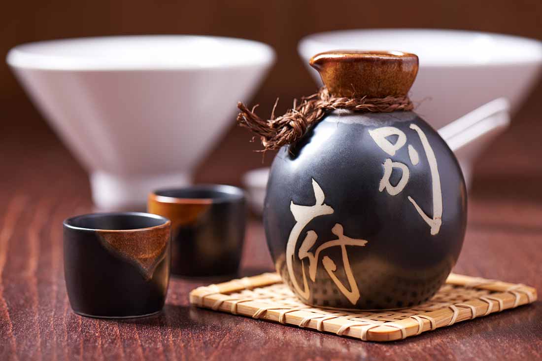 A Bottle of Japanese Sake and Two Traditional Drinking Cups.