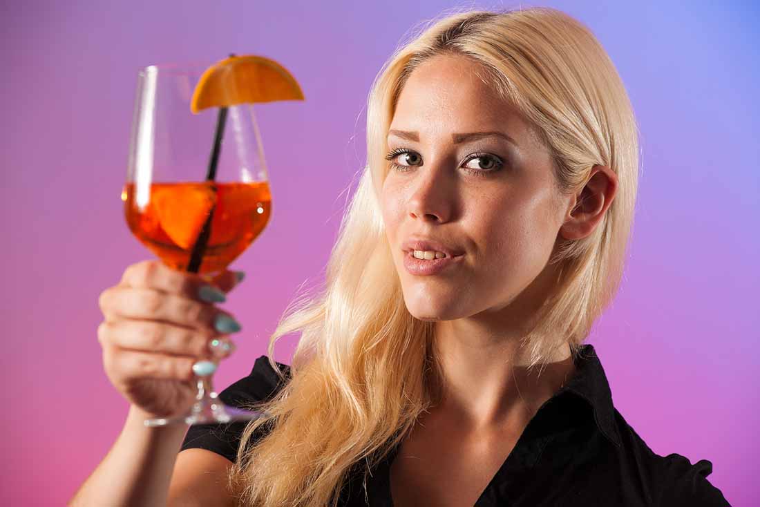 A Young Lady Holding a Cocktail Glass of Sangria.