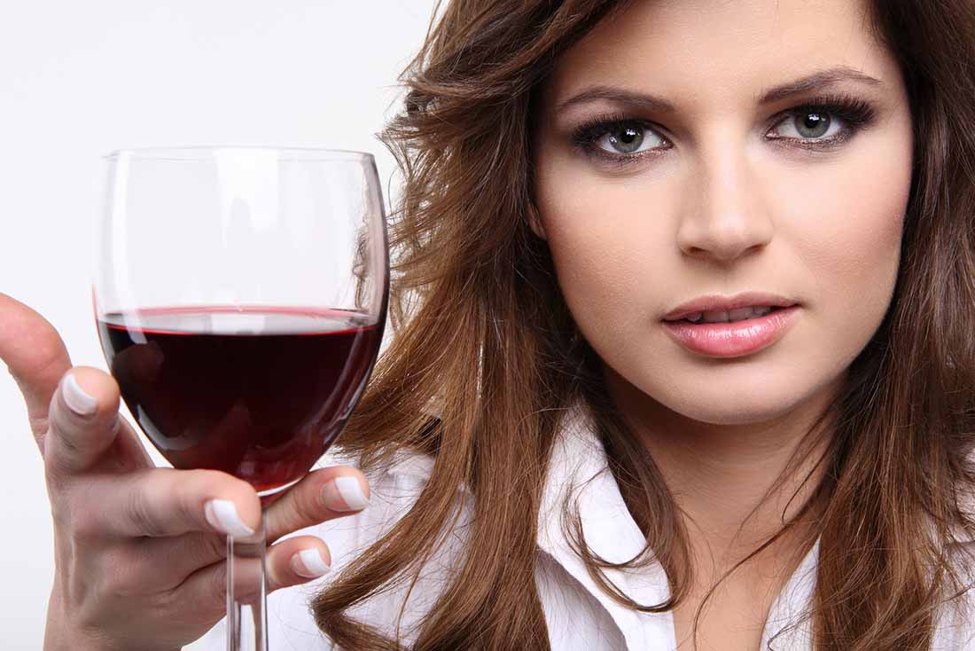 A Lady Holding a Glass of Red Wine.