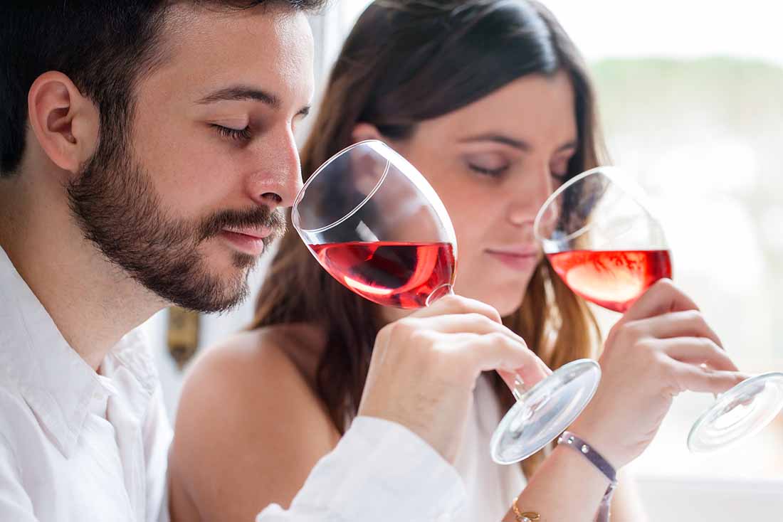 A Young Couple Drinking a Glass of Rose Wine.