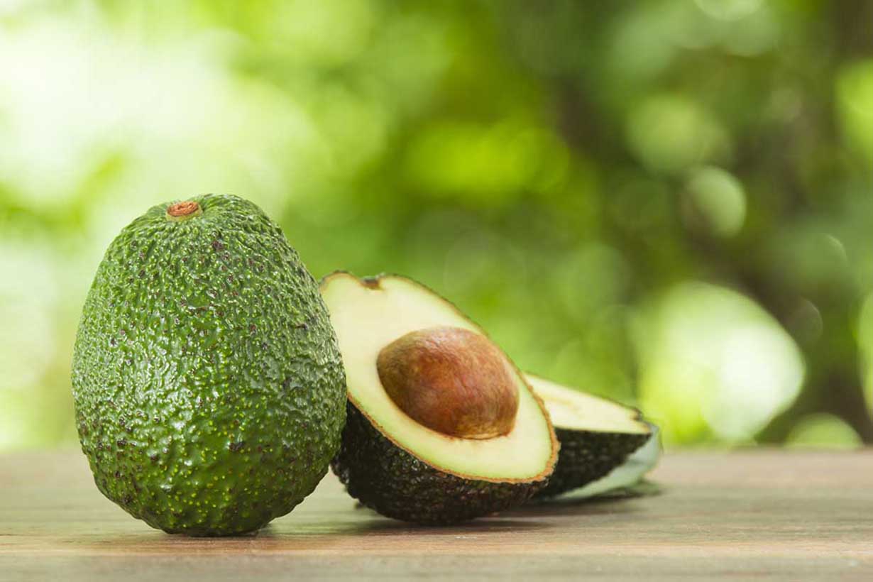 Picture of a Whole Avocado and Two Avocado Halves.