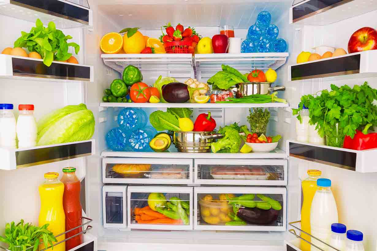 A Large Open Fridge Full of Fresh Produce.