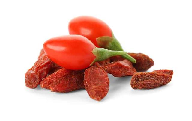 Fresh and Dried Goji Berries Next To Each Other.