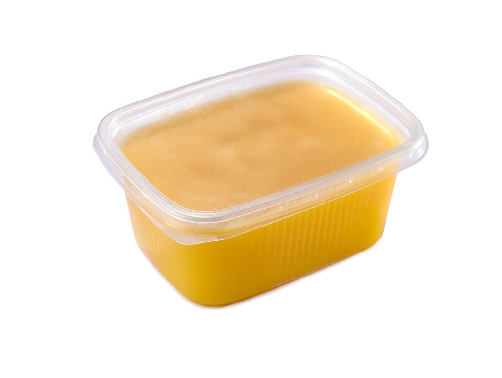 A picture of ghee in a plastic tub.