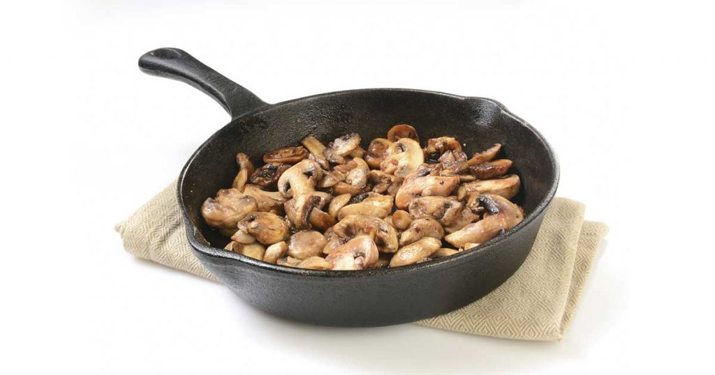 Sauteed mushrooms in a cast iron pan.