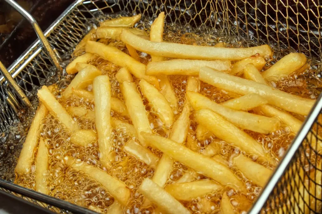 French fries being deep fried in oil.