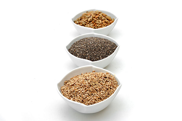 Various Edible Seeds In White Bowls - Includes Chia and Flaxseed.