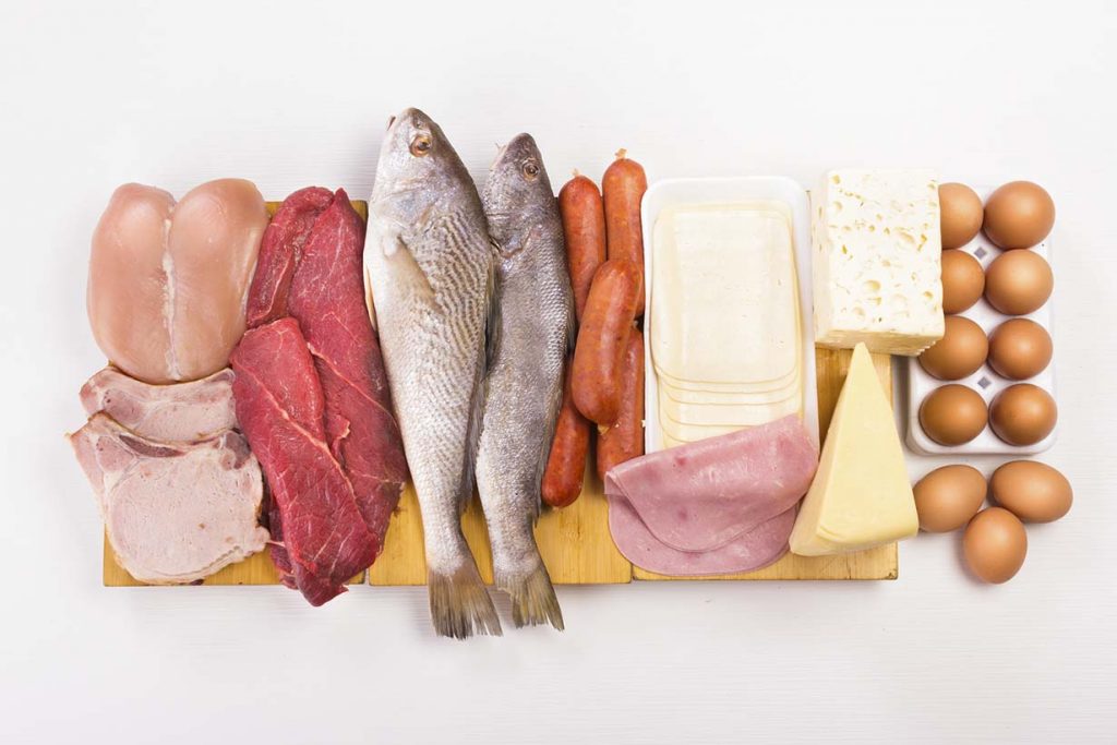 Various foods that are compatible with a ketogenic diet, including eggs, fish, meat, and cheese.
