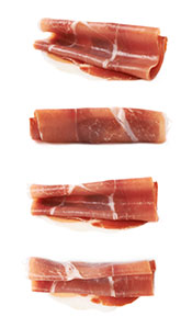 Prosciutto Slices Rolled Up On a White Background.