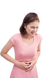 A Young Woman With Stomach Cramps Holding Her Stomach.