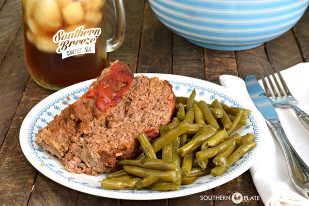 A Plate of Meatloaf Served Alongside Green Beans.