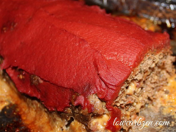 Picture of a cheese and tomato meatloaf rolled into a pinwheel.