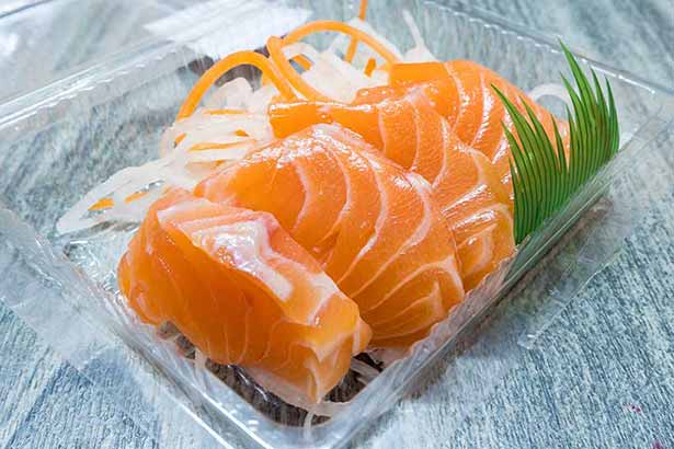 Thick Pieces of Salmon Sashimi On a Serving Tray.