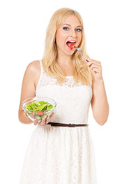 A Young Lady Eating a Salad.