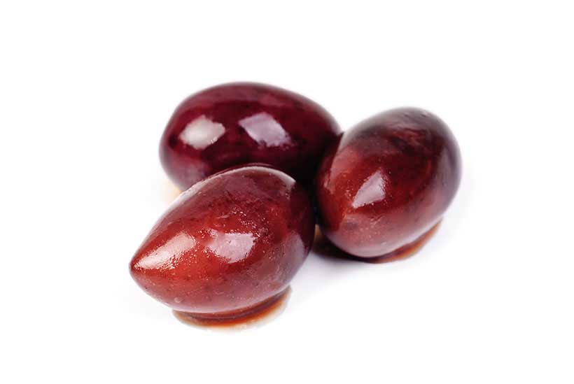 Three Kalamata Olives on a White Background.