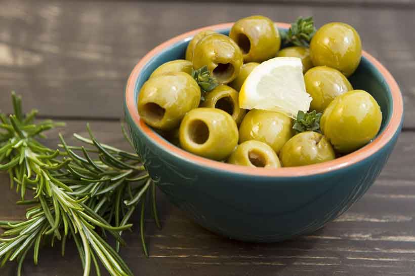 Manzanilla Pitted Olives in a Bowl Waiting on the Table. 