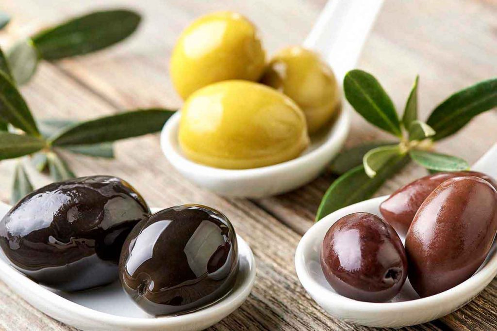 Three Types of Olives on a Table.