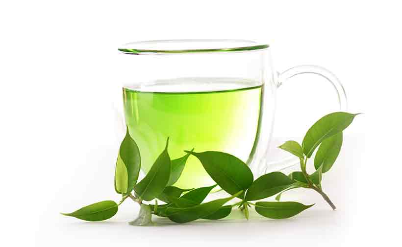 Picture of Green Tea With Leaves in a Glass Cup.