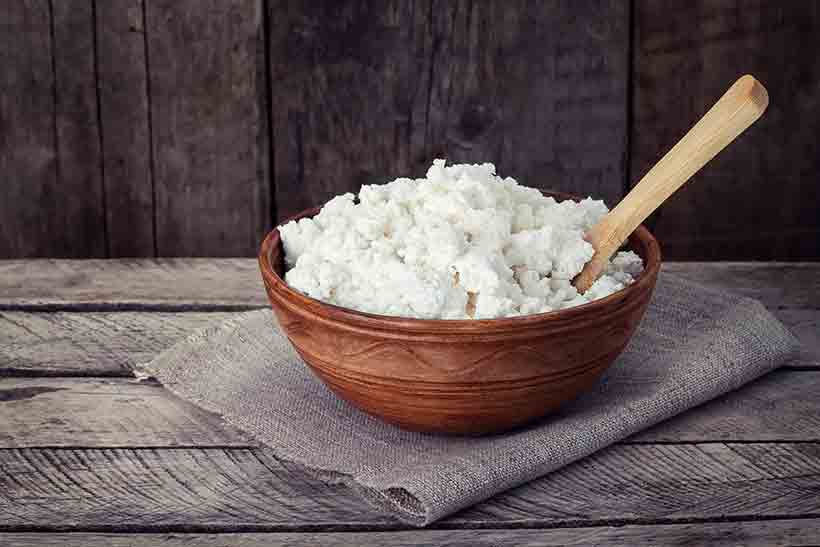 Fermented Cottage Cheese In a Brown Ceramic Bowl.