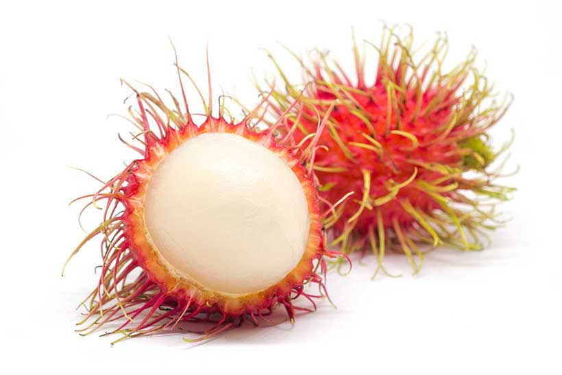 Two Rambutan Fruit: One is Whole, and One is Open.