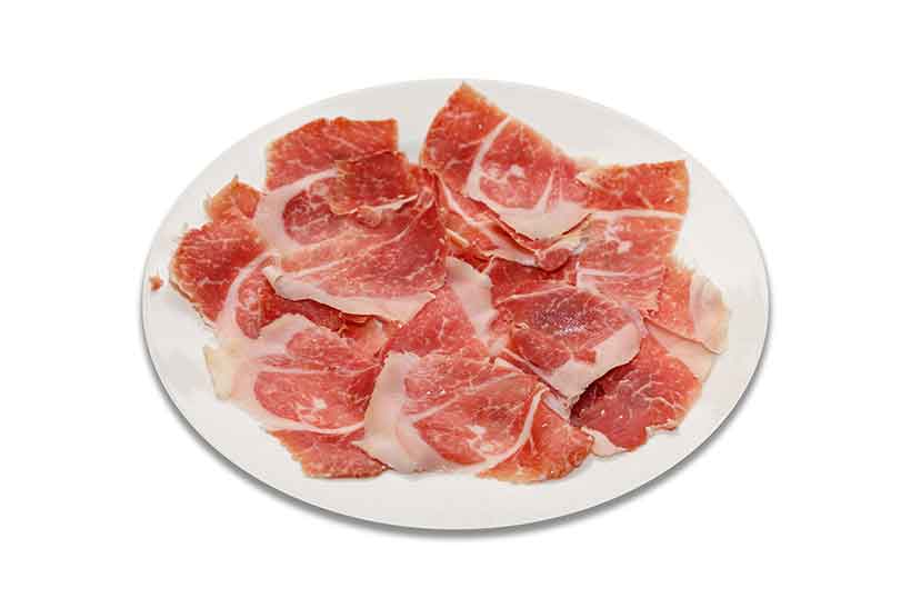 Many Slices of Jamon Cured Meat on a Plate.