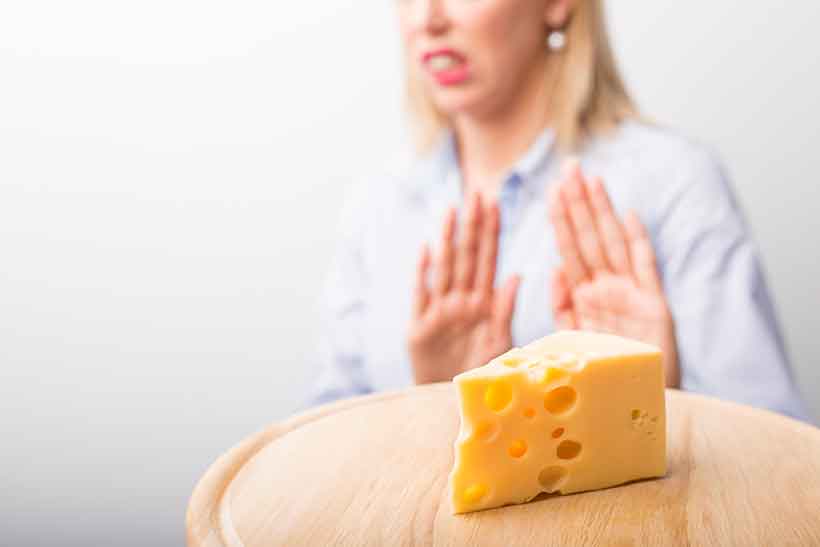 A Woman Making a Gesture Saying She Doesn't Want Cheddar Cheese.