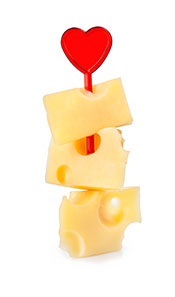 Several Pieces of Cheese Including Cheddar On a 'Kebab' Stick With Heart on Top.