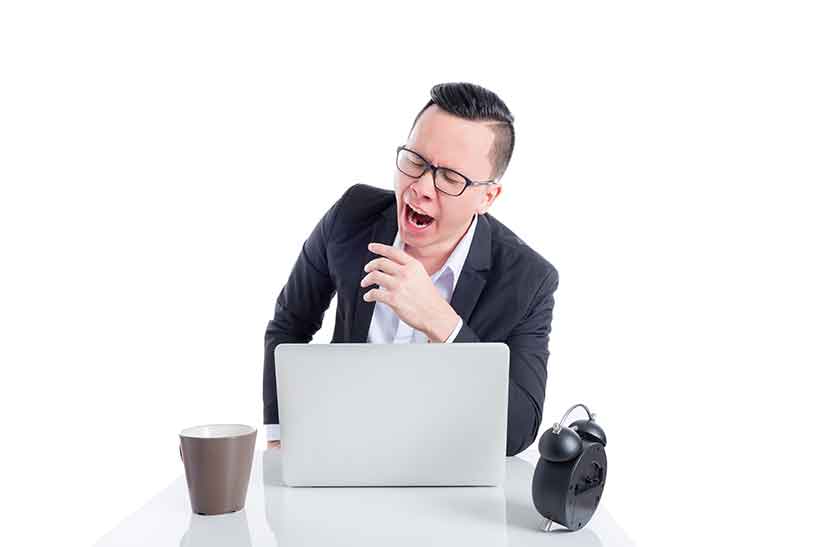 A Businessman Feeling Fatigued At His Desk.