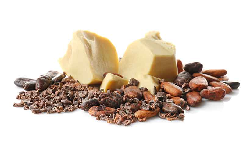 Picture of Cocoa Butter Chunks Next To Cocoa Beans and Nibs.