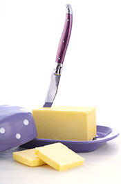 One Stick of Butter In a Butter Dish With a Knife.