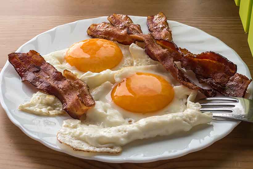 Bacon and Eggs: Two Fried Eggs and Streaks of Crispy Bacon.