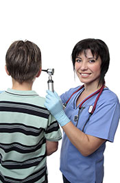 A Nurse Examining a Young Boy's Ear.