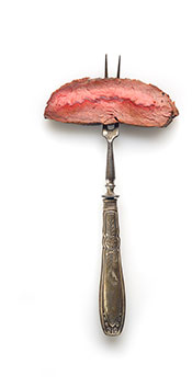 A Piece of Ribeye Steak on a Fork.