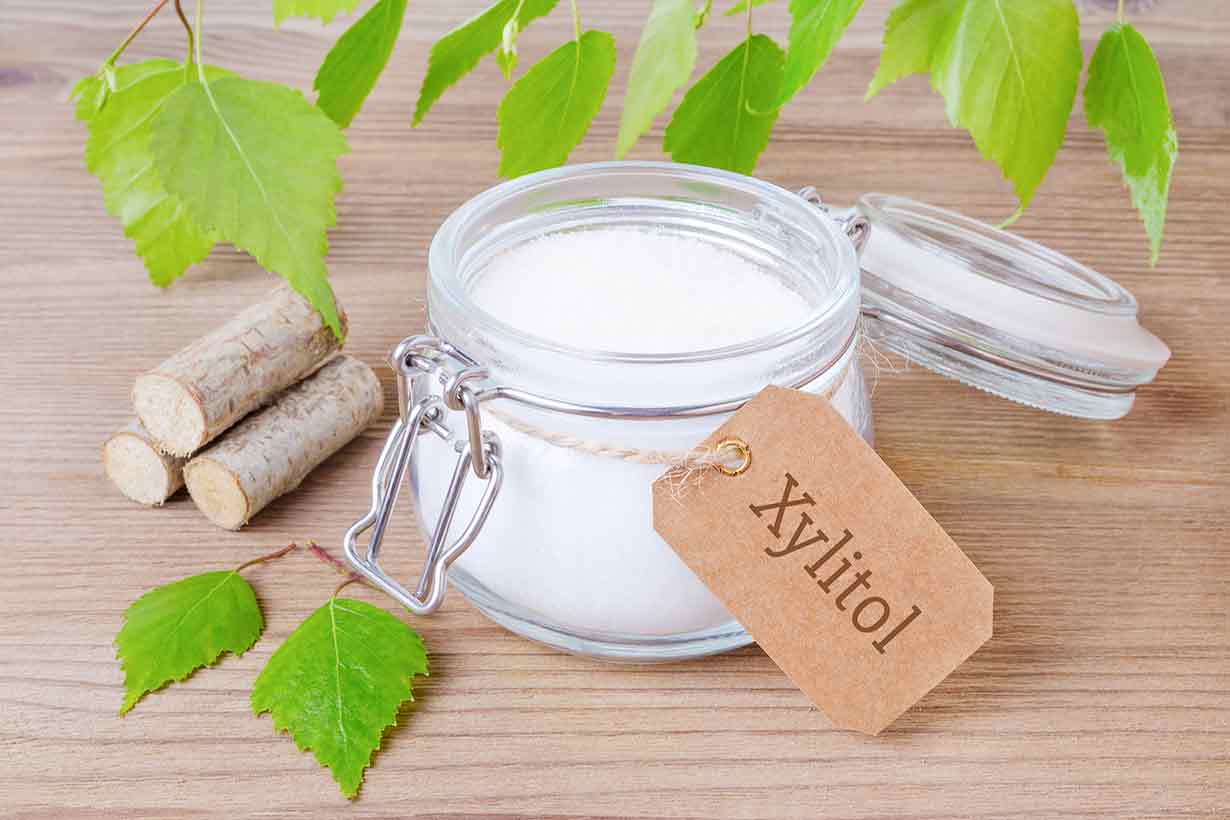 A Glass Jar of Powdered Xylitol On a Table.