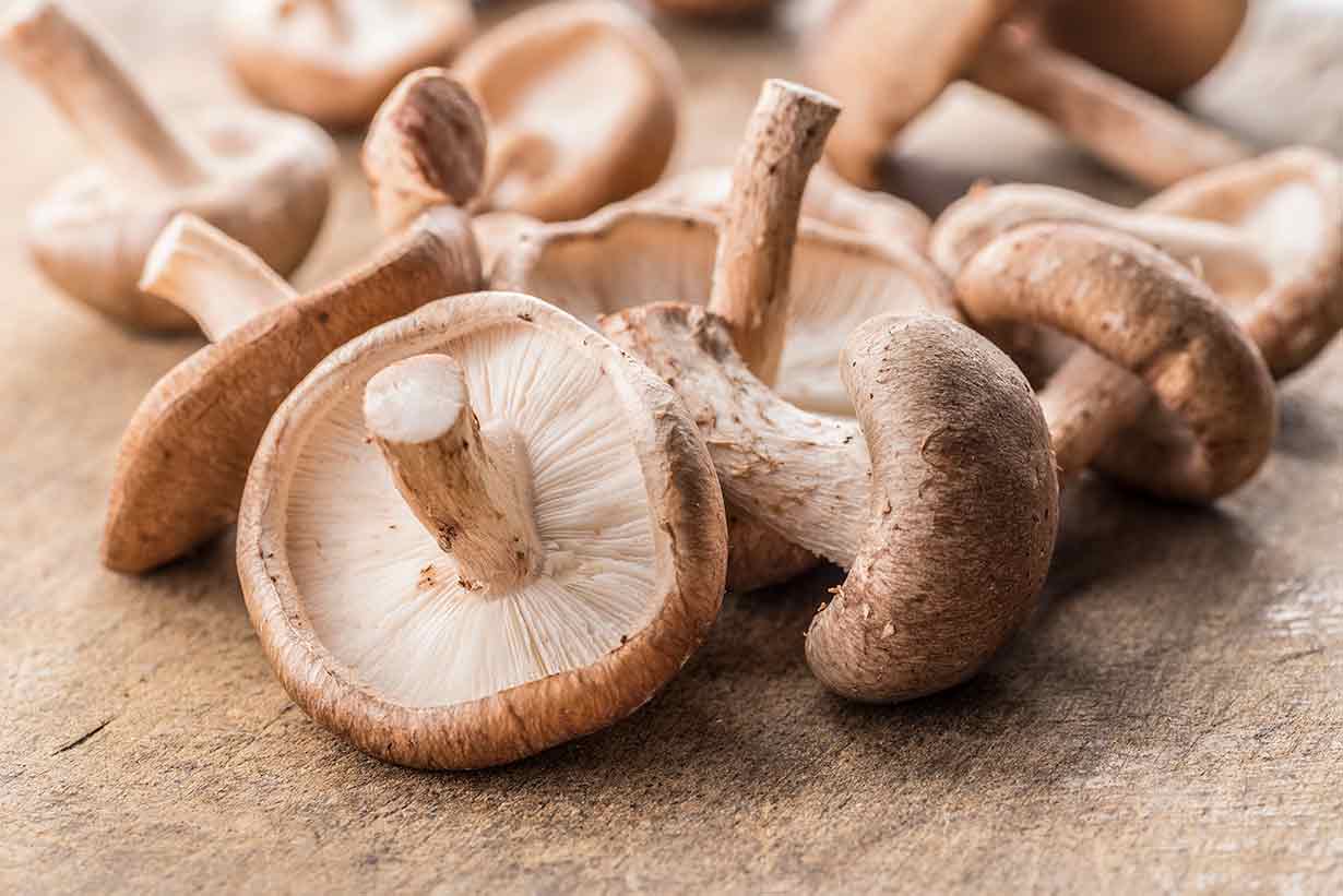 Shiitake Mushrooms On a Wooden Surface.