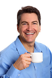 Smiling Business Man Wearing Formal Shirt Holding Cup of Coffee.