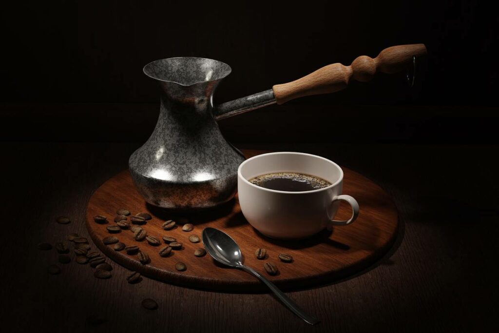 A cup of coffee and roasted coffee beans on a wooden table.