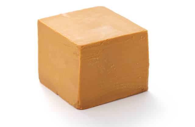 A piece of Gjetost (Norwegian brown cheese).