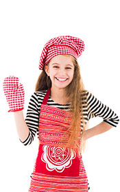 A Young Girl Wearing a Baking Glove and Baking Apparel.