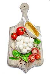 Fresh Italian Mozzarella Cheese On a Wooden Board With Tomatoes.