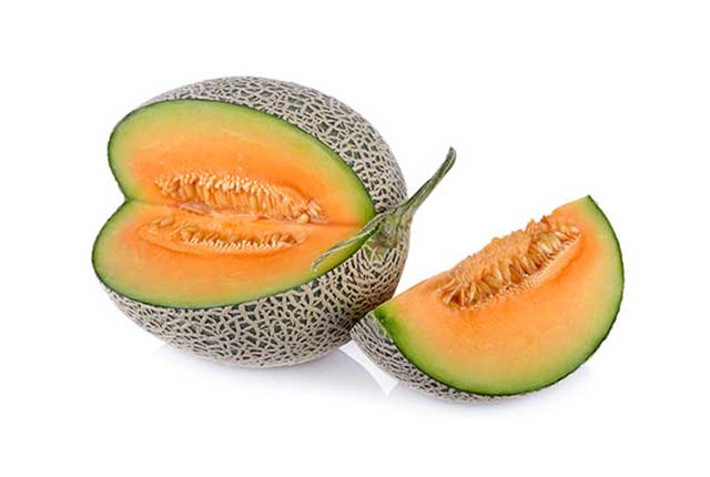 A Cantaloupe Melon On a White Background With One Slice Missing.