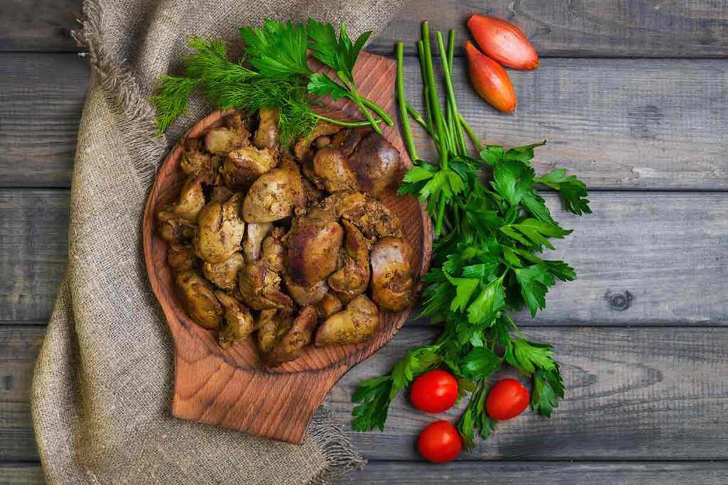 Chicken Livers On a Wooden Plate.