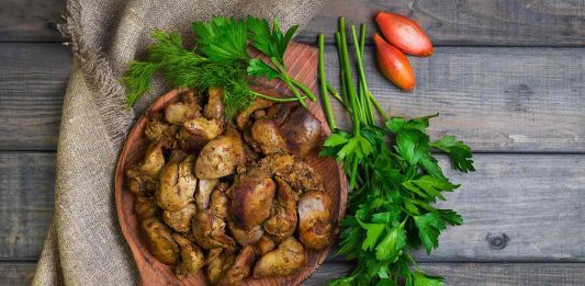 Chicken Livers On a Wooden Plate.