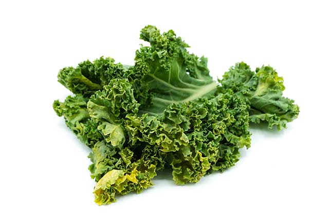 Dark Green Whole Kale Leaves on a White Background.