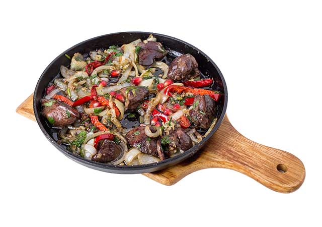 Fried Chicken Liver and Onions In a Cast Iron Pan.