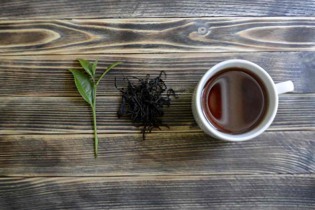 A Cup of Black Tea On a Wooden Table.